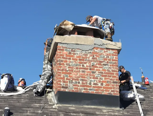 Guilford Chimney Sweep installing a custom chimney crown in Guilford, CT