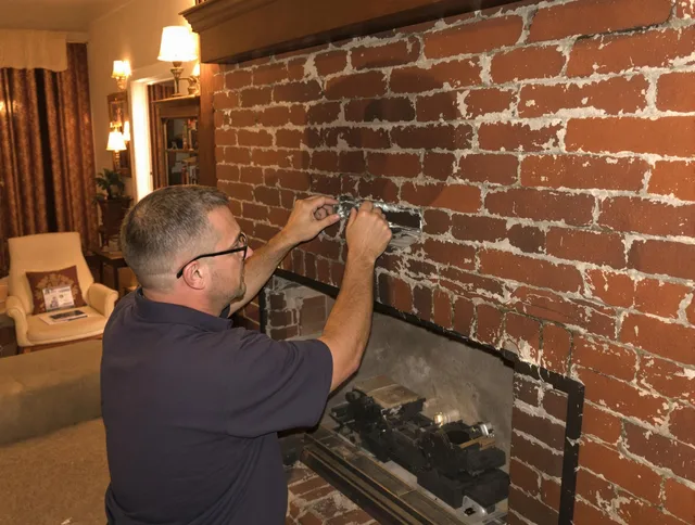Guilford Chimney Sweep expert fixing a fireplace in Guilford, CT